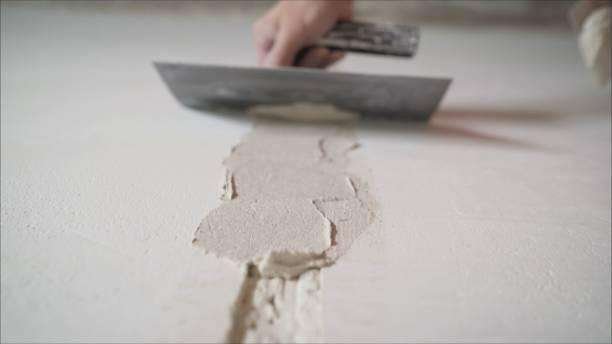 Professional plastering and rendering in Wolverhampton featuring a specialist applying a smooth, flawless finish to an interior wall.